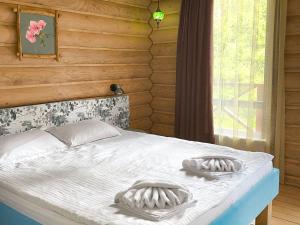 a bedroom with a bed with two towels on it at Власовъ in Pamporovo
