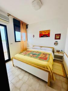 a bedroom with a large bed in a room at Giardino dei Trulli - Villa al Mare in Faccia di Trippa