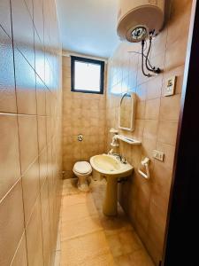 a small bathroom with a sink and a toilet at Giardino dei Trulli - Villa al Mare in Faccia di Trippa