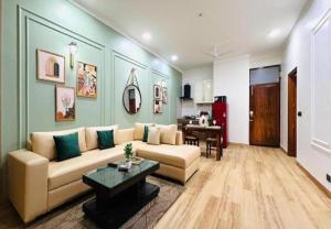 a living room with a couch and a table at BluO Awesome 1BHK DLF Galleria Market ,Gym TT in Gurgaon +5 photos