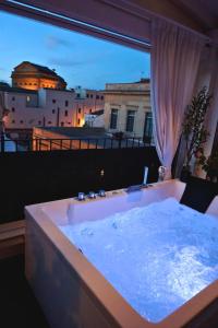 a bath tub with a view of a city at Teatro Massimo Terrace relax suite in Palermo