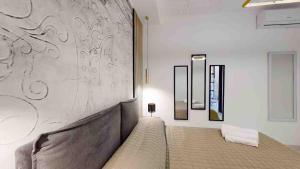 a bedroom with a bed and a wall at Teatro Massimo Terrace relax suite in Palermo
