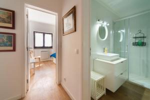 a bathroom with a sink and a glass shower at Cascais Bay in Cascais +19 photos