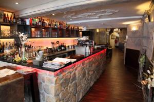 a bar in a restaurant with a brick wall at Pension Villa Colosseo im Herzen von Meiningen in Meiningen