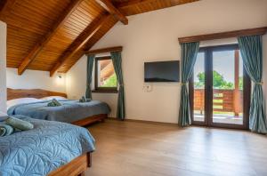 a bedroom with two beds and a flat screen tv at Villa Brusiana with heated pool in Brušane +36 photos
