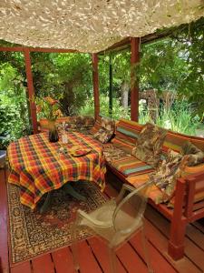 a porch with a couch and a table and chairs at Artist's house for rent in Guérande