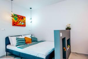 a small bed in a room with a painting on the wall at Studio Filipos in Kallithea Halkidikis +7 photos