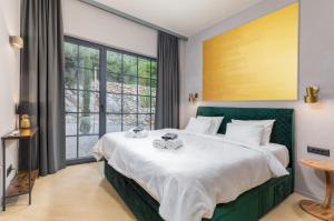 a bedroom with a large bed and a large window at Villa St Hedonist by Villsy in Poljane +53 photos