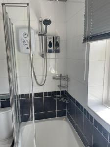 a bathroom with a shower and a bath tub at Camaraderie Guest House in York