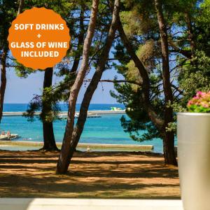a sign that reads soft drinks glass of wine involved at Hotel Flores in Poreč