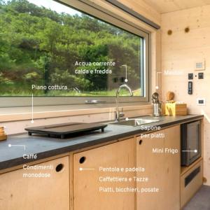a kitchen with a sink and a window at Una Stanza con vista tra le colline senesi - Friland in Fattoria Falsini