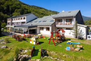 a yard with playground equipment in front of a house at Hotel Bystrá in Brezno