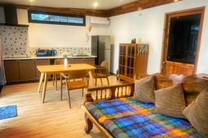 a living room with a couch and a table at Colibri Beach Resort in Chaloklum