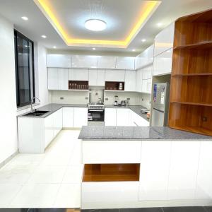 una cucina con armadi bianchi e soffitto di Luxurious & Spacious Mega Home! ad Addis Abeba