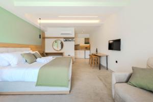 a bedroom with a large bed and a couch at Emerald Project in Limenas
