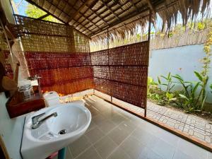 a bathroom with a sink and a large window at Muong Dinh Lodge in Ấp Nhơn Bình