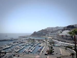a harbor with a bunch of boats in the water at Holiday Club Puerto Calma in Puerto Rico de Gran Canaria