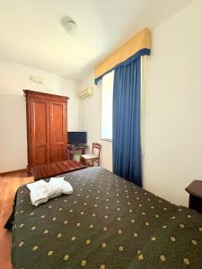 Letto o letti in una camera di Hotel Archimede Ortigia