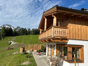 a house with a balcony on the side of it at Filzsteinresort Chalets - Chalet 235 in Krimml