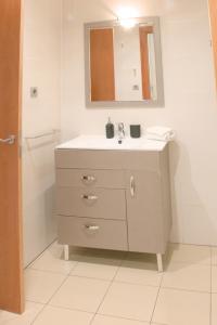 a bathroom with a sink and a mirror at SWEET BCN Plaza Universidad in Barcelona