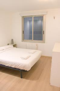a large bed in a room with a window at SWEET BCN Plaza Universidad in Barcelona +3 photos