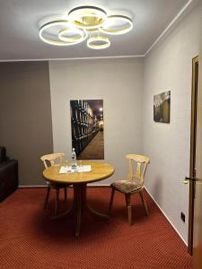 a dining room with a table and two chairs at Lesura Ferien- Apartment in Lieser