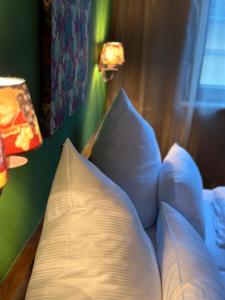a bedroom with a bed with pillows and a lamp at Lesura Ferien- Apartment in Lieser