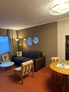 a living room with a couch and a table at Lesura Ferien- Apartment in Lieser
