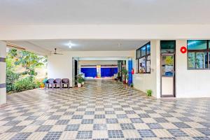an empty room with a tile floor and windows at Hotel O Beach Road Near GITAM in Visakhapatnam +16 photos