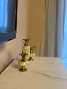 three vases sitting on a table in front of a tv at Lesura Ferien- Apartment in Lieser +4 photos
