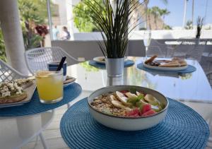 a table with a bowl of food and a drink at Holiday Club Puerto Calma in Puerto Rico de Gran Canaria