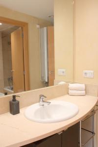 a bathroom with a sink and a mirror at SWEET BCN Rambla 48 in Barcelona