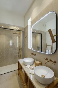 a bathroom with a sink and a mirror and a shower at COOL DREAMS Luxury Rooms in Siracusa