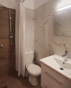 a bathroom with a toilet and a sink at Galazio suites 1 Seaside in Salamina +22 photos