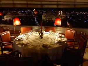 a table with wine glasses and a view of a city at Hotel Miradouro in Porto +36 photos