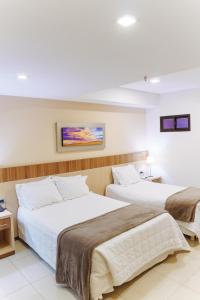 Rúm í herbergi á Bella Vista Hotel - Encarnación