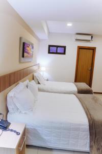 Rúm í herbergi á Bella Vista Hotel - Encarnación