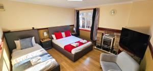 a small bedroom with a bed and a tv at Duddingston 9 Bedroom House - Edinburgh in Edinburgh