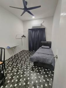 a bedroom with a bed and a ceiling fan at Rumah Pak Syed in Ipoh +1 photo