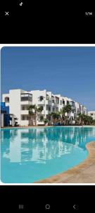 a large swimming pool in front of a building at Mansouria beach resort in Mohammedia