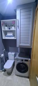 a bathroom with a washing machine and a toilet at Mansouria beach resort in Mohammedia +12 photos