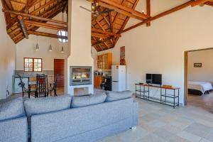 a living room with a blue couch and a kitchen at Stunning Bushveld Villa 84 in Warmbaths