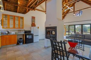 a kitchen with a table and chairs in a room at Stunning Bushveld Villa 84 in Warmbaths