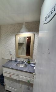 a bathroom with a sink and a mirror at Donde brilla el sol in Dina Huapi +7 photos