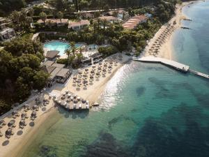 an aerial view of a resort with umbrellas and a beach at Eagles Palace - Small Luxury Hotels of the World in Ouranoupoli