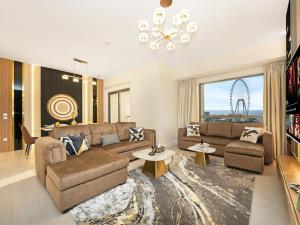 a living room with a couch and a table at Dubai Eye & Palm View #JBR Beach # ULTRA Luxurious 2 BHK in Dubai