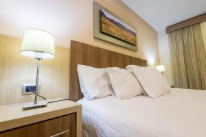Rúm í herbergi á Bella Vista Hotel - Encarnación