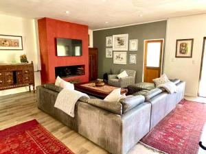 a living room with a couch and a fireplace at Bryan's View in Windhoek