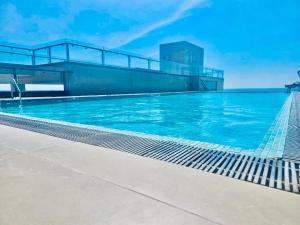 a swimming pool on top of a building at Ocean Breeze Pearl in Negombo