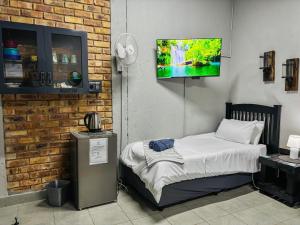 a room with a bed and a flat screen tv at Calabash Executive Stay in Benoni